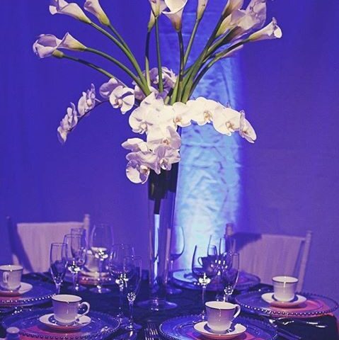 tall white wedding centerpiece with orchids