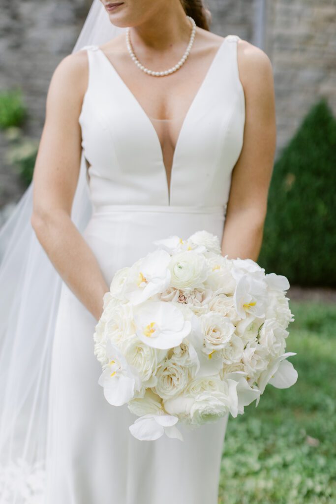 bridal bouquet of white roses and white orchids 