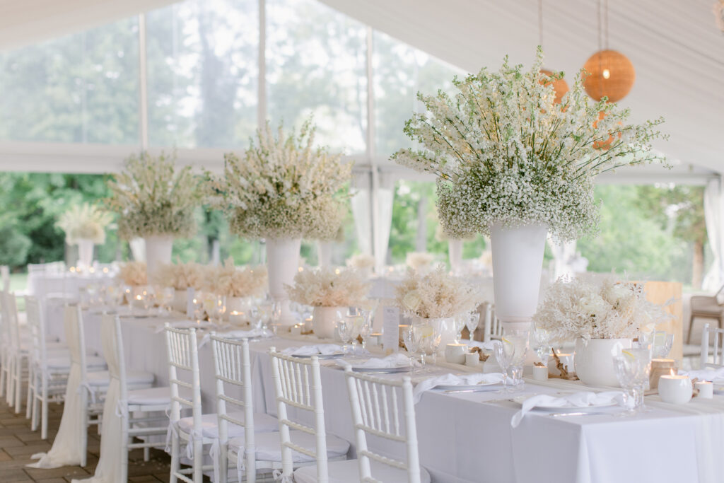  long table with multiple centerpieces, white tall centerpiece, white flower urn