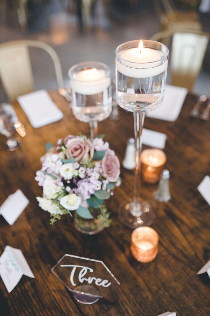 centerpiece gold votive bouquet floating candles table number fall colors dusty pink dust purple glamorous industrial venue floral v designs 