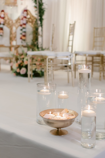 floating candles and rose petals in cylinder vases 