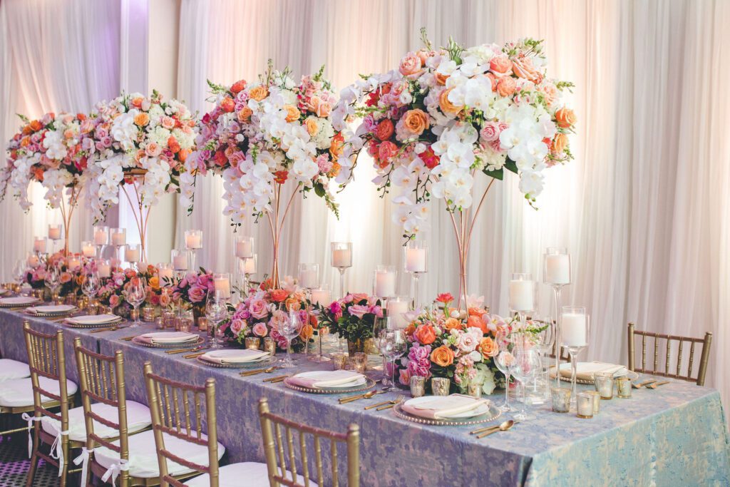 The Dayton Arcade tall wedding reception centerpieces on head table with candles