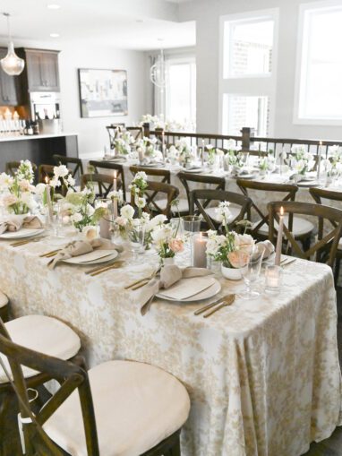 long banquet table filled with flowers and candles